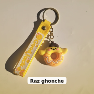 cute yellow donut‑shaped character keychain with brown hat and yellow silicone strap printed “Good Luck”, RAZ GHONCHE