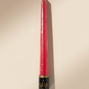 single tall red taper candle wrapped in clear plastic with black‑gold “Golden Candle” base label on beige background, RAZ GHONCHE