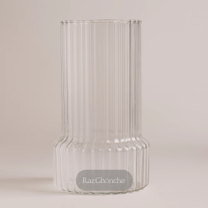 clear ribbed glass vase with cylindrical shape and fluted texture, minimalist beige background, RAZ GHONCHE