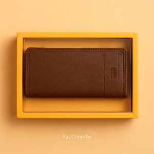 brown leather men’s wallet in yellow gift box on beige background, minimalist design, RAZ GHONCHE