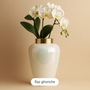 white artificial orchid flowers with green leaves in glossy pearl-white vase with golden rim, beige background, RAZ GHONCHE