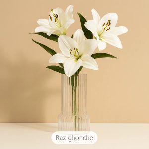 white artificial lilies bouquet with green leaves in clear ribbed glass vase, beige background, RAZ GHONCHE