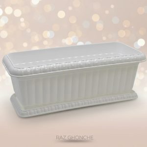 White rectangular plastic planter box with elegant decorative edges, displayed against a soft beige background with warm bokeh lights.