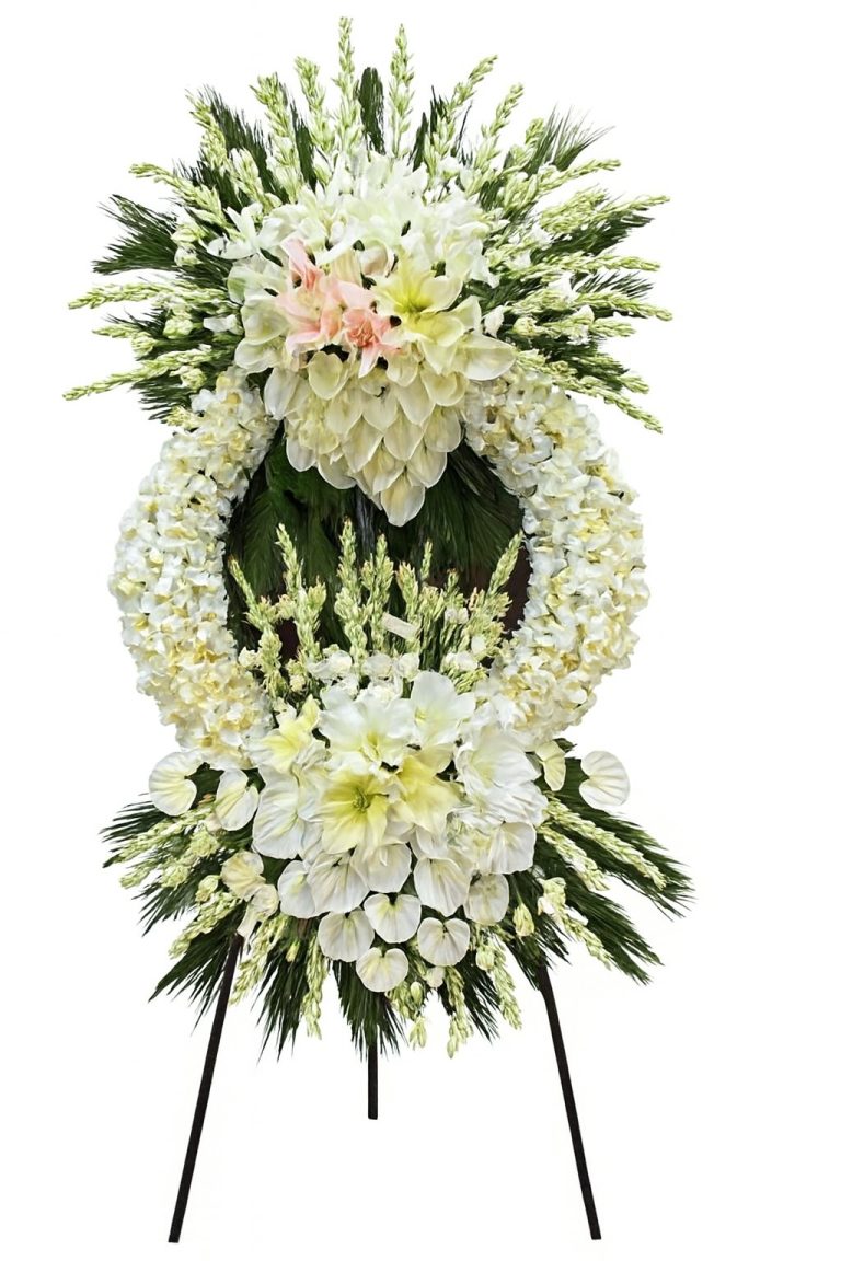 Luxury white ceremonial floral stand with lilies, gladiolus, anthuriums and premium greenery on a tall black stand.