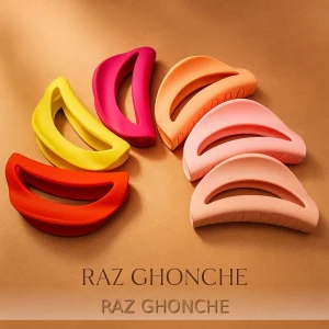 matte colorful plastic crescent hair clips in vibrant shades of pink, yellow, orange, and peach displayed on a golden background, RAZ GHONCHE