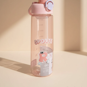 A large, clear sport water bottle with a slight pink tint, featuring measurement markings and a pink flip-lock lid. The bottle is decorated with the word “SPORTS” and a cartoon sticker of the letter ‘R’ with eyes and feet. The lid has a small lavender-colored lock mechanism.